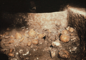 Benches and ceramics found in Tomb 5, from hand-colored lantern slide